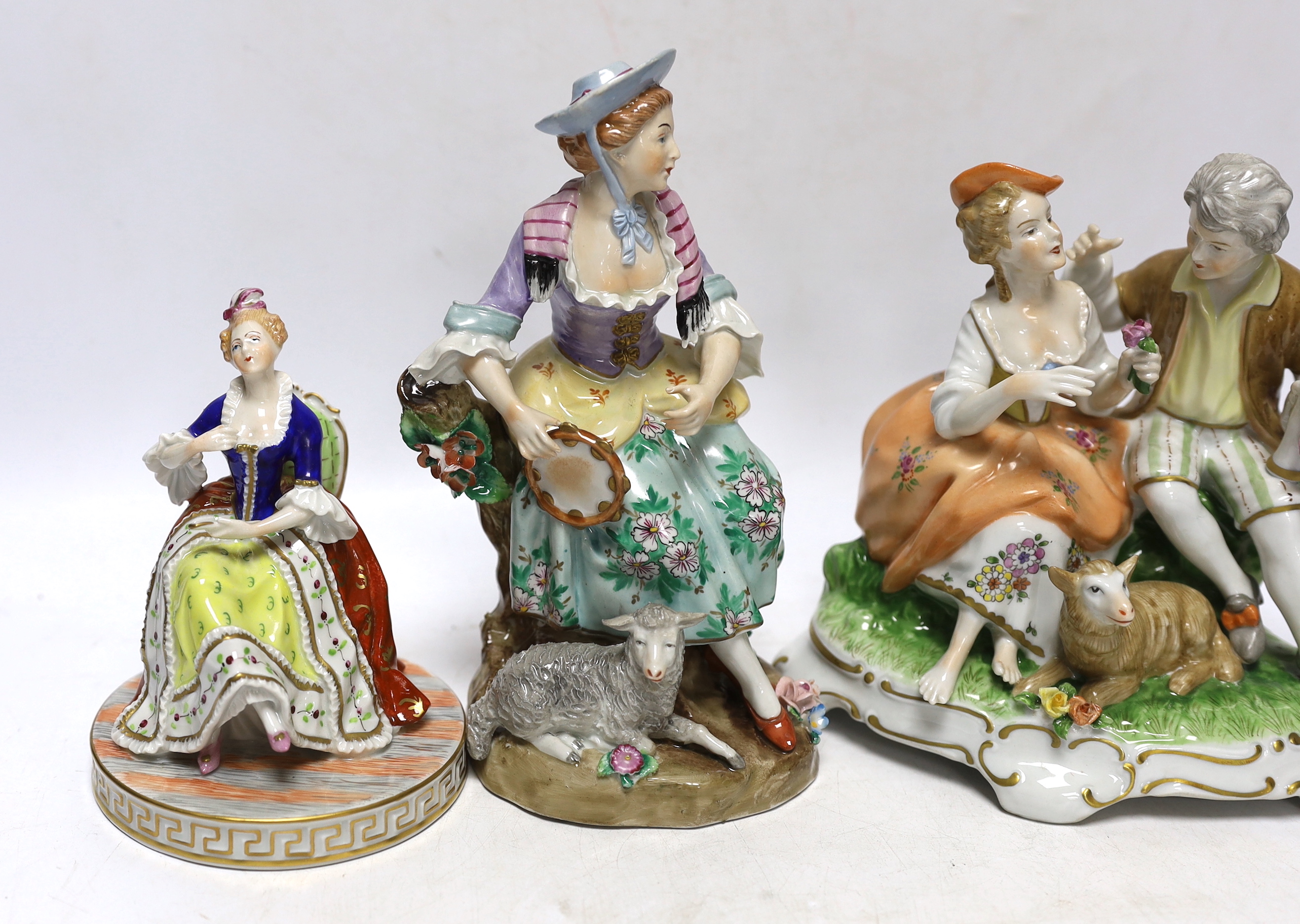 A pair of Dresden figures, a Sitzendorf shepherdess group and another German group